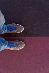 Concept of facing a crucial decision shown by shoes on different colored pathways