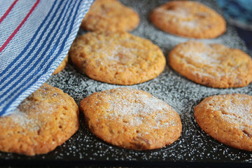 baking tray with cookies and a kitchen towel