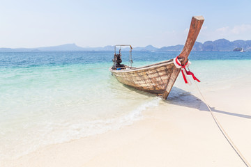 Fototapeta na wymiar Longtail boat mooring on the tropical beach in the andaman sea krabi Thailand on sunny day