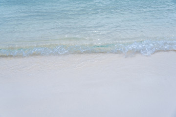 closed up clear and blue wave of the sea on white beautiful island beach