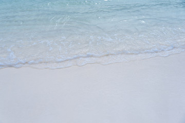 closed up clear and blue wave of the sea on white beautiful island beach