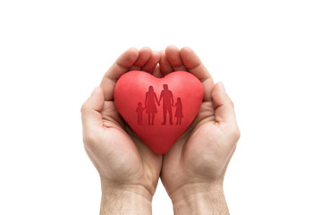 Red heart with imprinted family shape in man's hands.