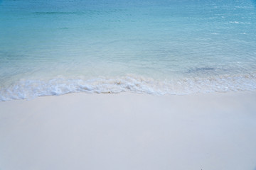 closed up clear and blue wave of the sea on white beautiful island beach