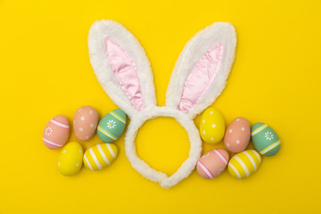 Easter holiday background with bunny ears and easter eggs