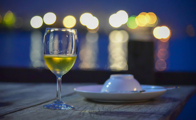 A glassA glass of wine put on dinner table with blow of soup in the restaurant