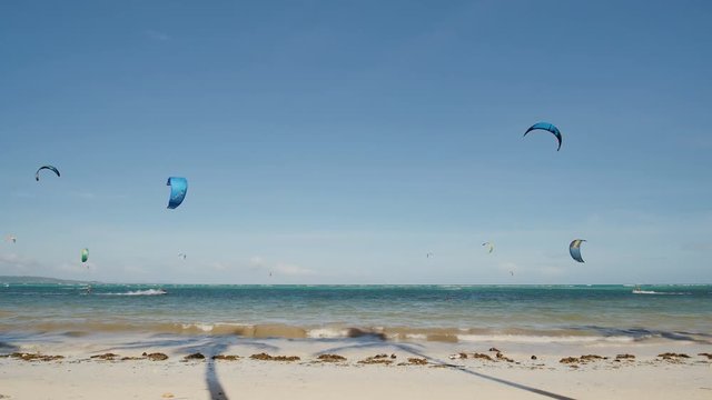 Kiteboarding. People enjoying the energy of the wind on the beach of the island of Boracay. Philippines.
