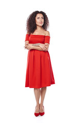Beautiful curly female in red dress and red high heels shoes in full length looking away at blank copy space