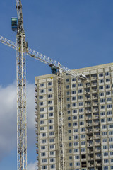 Fototapeta na wymiar two white building cranes at work