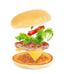 burger components in flight on white background