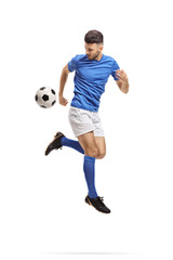 Soccer player performing a trick with a football in mid-air