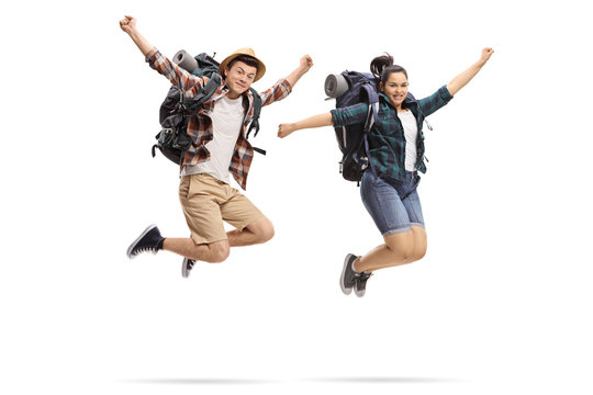 Teenage tourists jumping and gesturing happiness