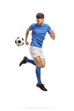 Fototapeta Soccer player performing a trick with a football in mid-air