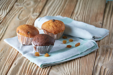 Tasty muffins arranged in pattern on light textured background, close-up, shallow depth of field, selective focus.
