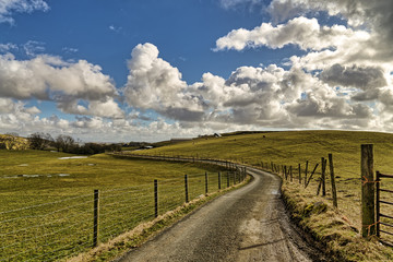 Fototapeta na wymiar An English country lane leading through farmland.