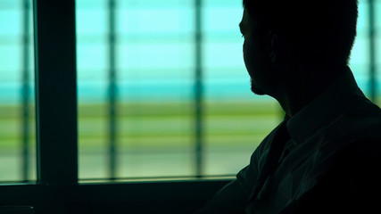 Pensive man having cup of coffee in waiting room, bored with everyday routine