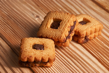 Chocolate sand chip cookies stacked up on a plate, ready to be served on wooden background