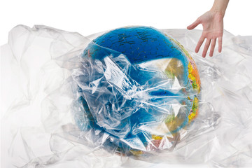 Human hand near the globe which is all in plastic, our irresponsible, excessive consumption of plastic, human wants to save world, social advertising, world environment day concept