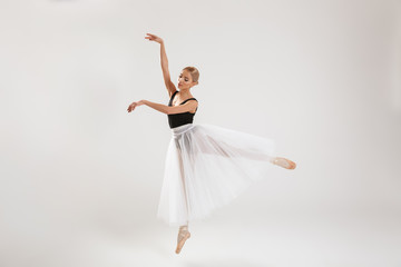 Fototapeta na wymiar Beautiful young woman ballerina dancing