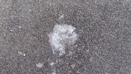 The texture of the asphalt and snow.