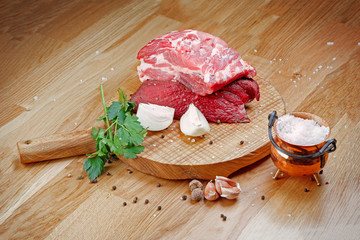 Raw beef meat on  wooden board.