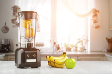 Blender, fruits and kitchen space. Sun flare