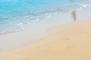 Fototapeta na wymiar Quiet, calm sea and yellow, fine sand beach. Copy space for text