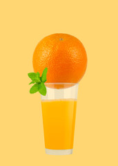 Glass of orange juice with orange