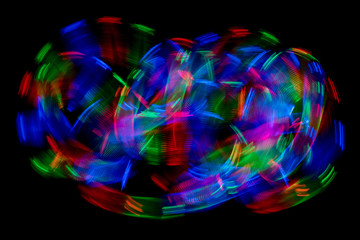 Multi color abstract light painting. LED lights on black background