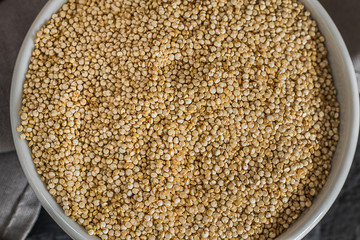 Quinoa seeds in a bowl and spoon