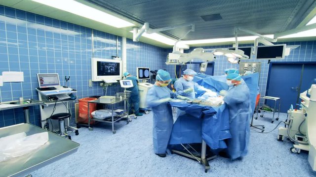 Timelapse Hospital Surgery team. Hospital surgery team operating a patient 