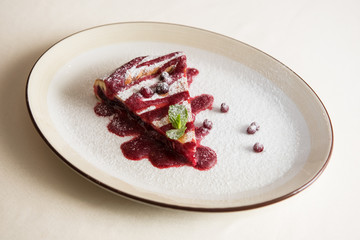 tasty cake with cowberry and fresh mint