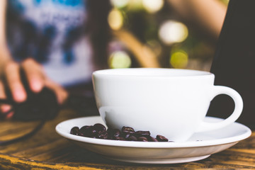 Young woman hands using mouse laptop on table with coffee cup. 