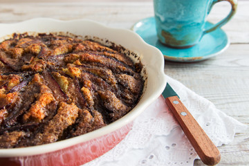 Plum traditional cake wooden background pottery cup.