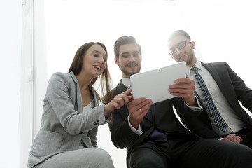 three business people are looking at a tablet PC