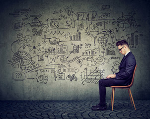 Businessman working with laptop on a business plan