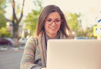 attractive woman using laptop outside