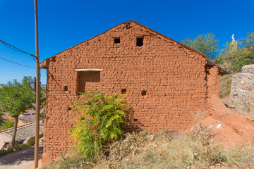 Fototapeta na wymiar wall side of house built with adobe bricks, roof open gable, in nature, in old town of Ayllon village, Segovia, Spain, Europe 