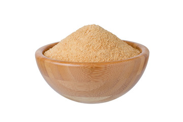 wooden bowl with organic coconut sugar isolated on white