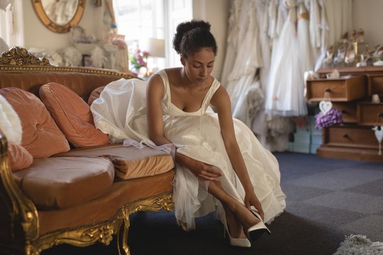 Young bride in wedding dress wearing high heels