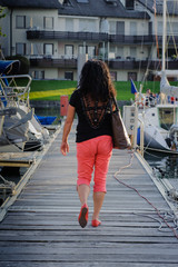 Woman walking away on a mooring