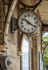 Fototapeta na wymiar Old clock outside on wall in train station, grunge effect