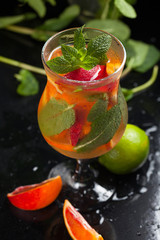 Fresh summer cold orange cocktail with lime and mint