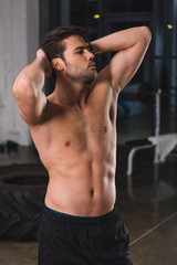 Fototapeta na wymiar shirtless muscular sportsman posing in sports hall