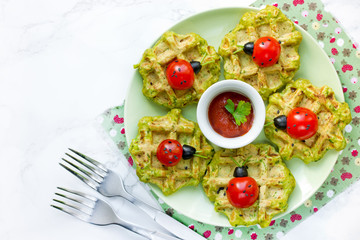 Ladybug sandwiches with cherry tomatoesand olives on spinach salty waffles