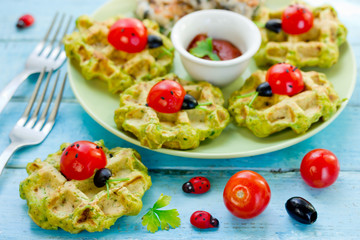 Ladybug sandwiches with cherry tomatoesand olives on spinach salty waffles