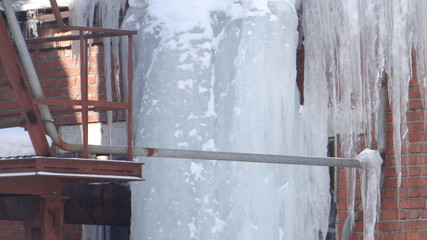 Icicles on a brick wall background.