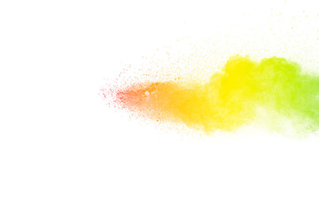 Freeze motion of color particles on white background. Multicolored granule of powder explosion. Abstract color dust overlay texture.