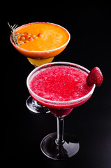 two classic and strawberry margarita, white and red alcoholic cocktail with decoration of salt on the edge of the glass with fresh lime, lemon, daiquiri on gray background restaurant. Bar alcohol menu