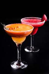 two classic and strawberry margarita, white and red alcoholic cocktail with decoration of salt on the edge of the glass with fresh lime, lemon, daiquiri on gray background restaurant. Bar alcohol menu