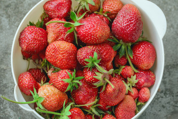 Fresh strawberries in a white plate close-up